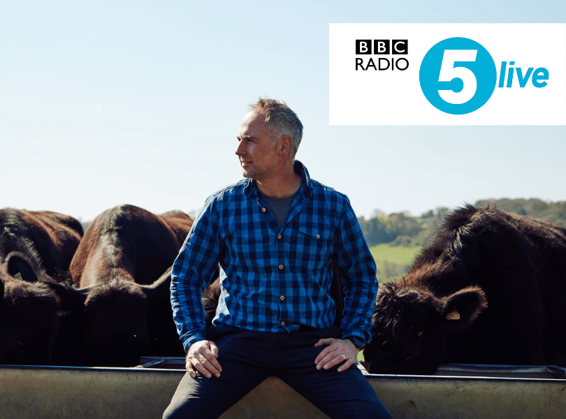 Jamie sat with cows behind him and the BBC radio 5 logo overlaid.