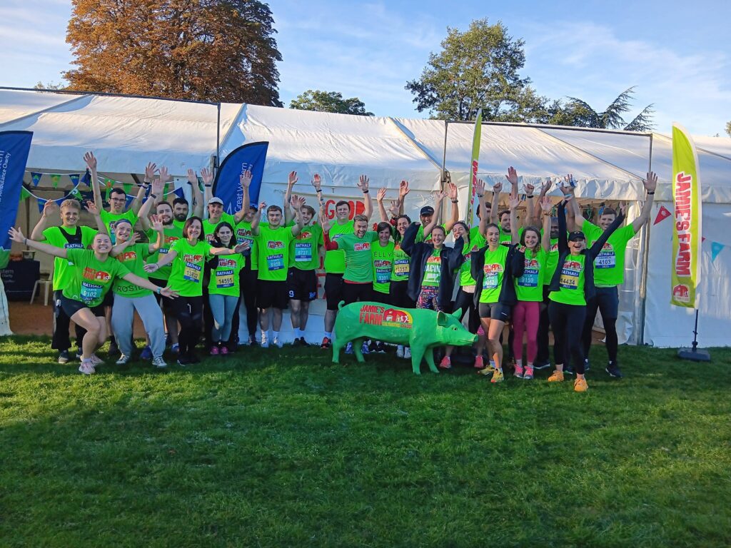 A group of runners wearing bright green running tops ahead of the Bath Half marathon.