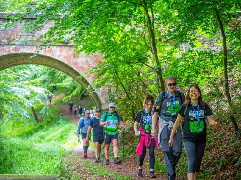 Group of people walking through a tunnel in the countryside
