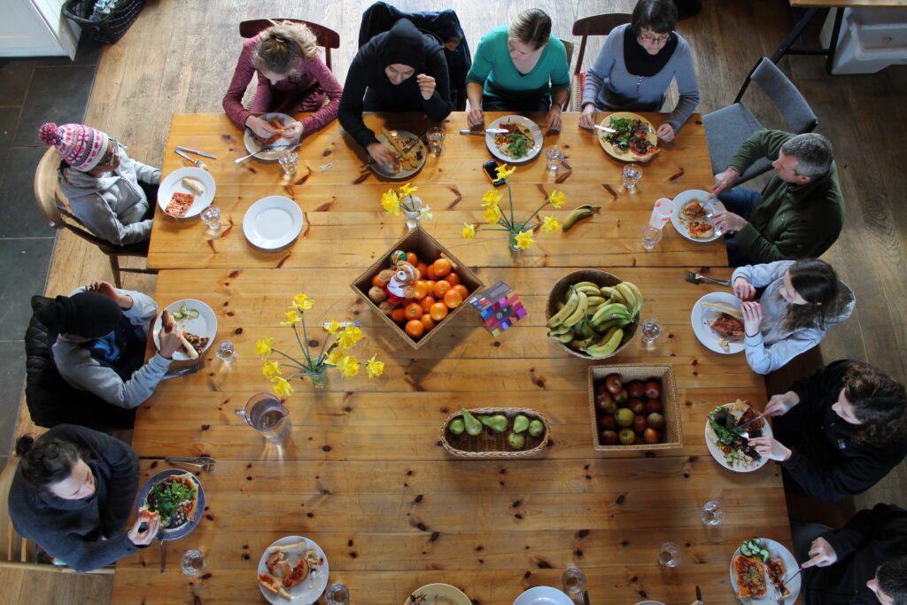 young people sitting round the dinner table together