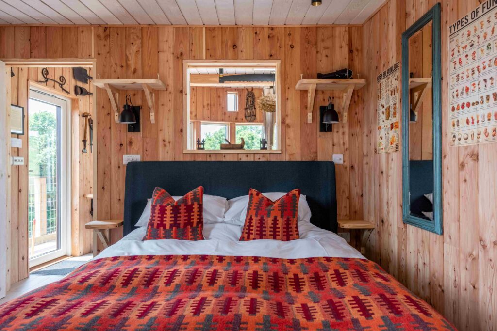 Cozy cabin bedroom with double bed in Wye Valley countryside stay