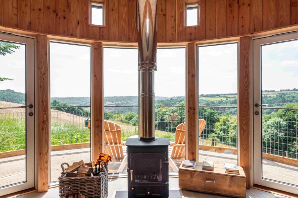 Wooden cabin with log burner and panoramic windows overlooking the Wye Valley countryside