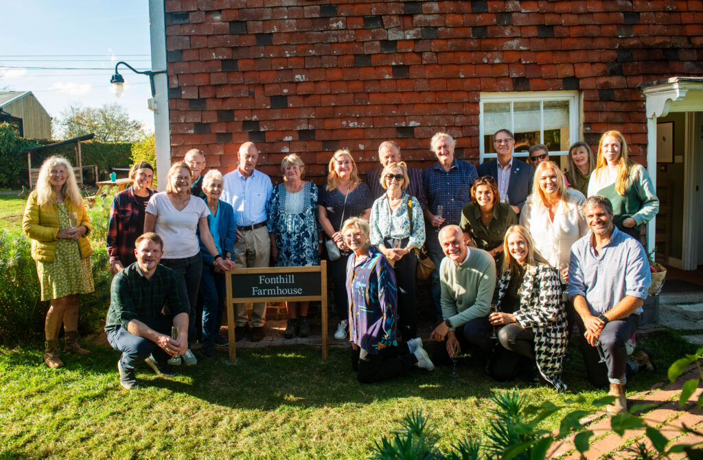The Fonthill Foundation team are stood around the new Fonthill Farmhouse sign 