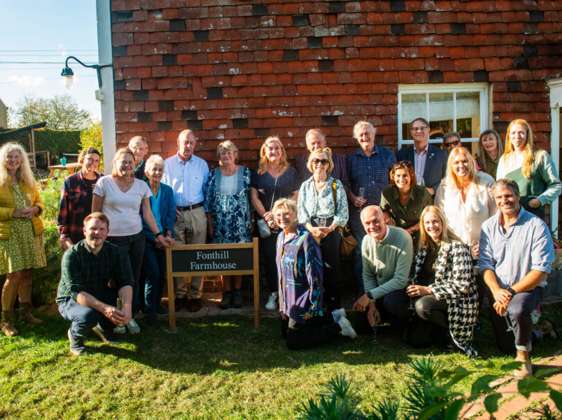 Fonthill Foundation team smiling at the camera, stood around the new Fonthill Farm sign at jamie's farm Lewes